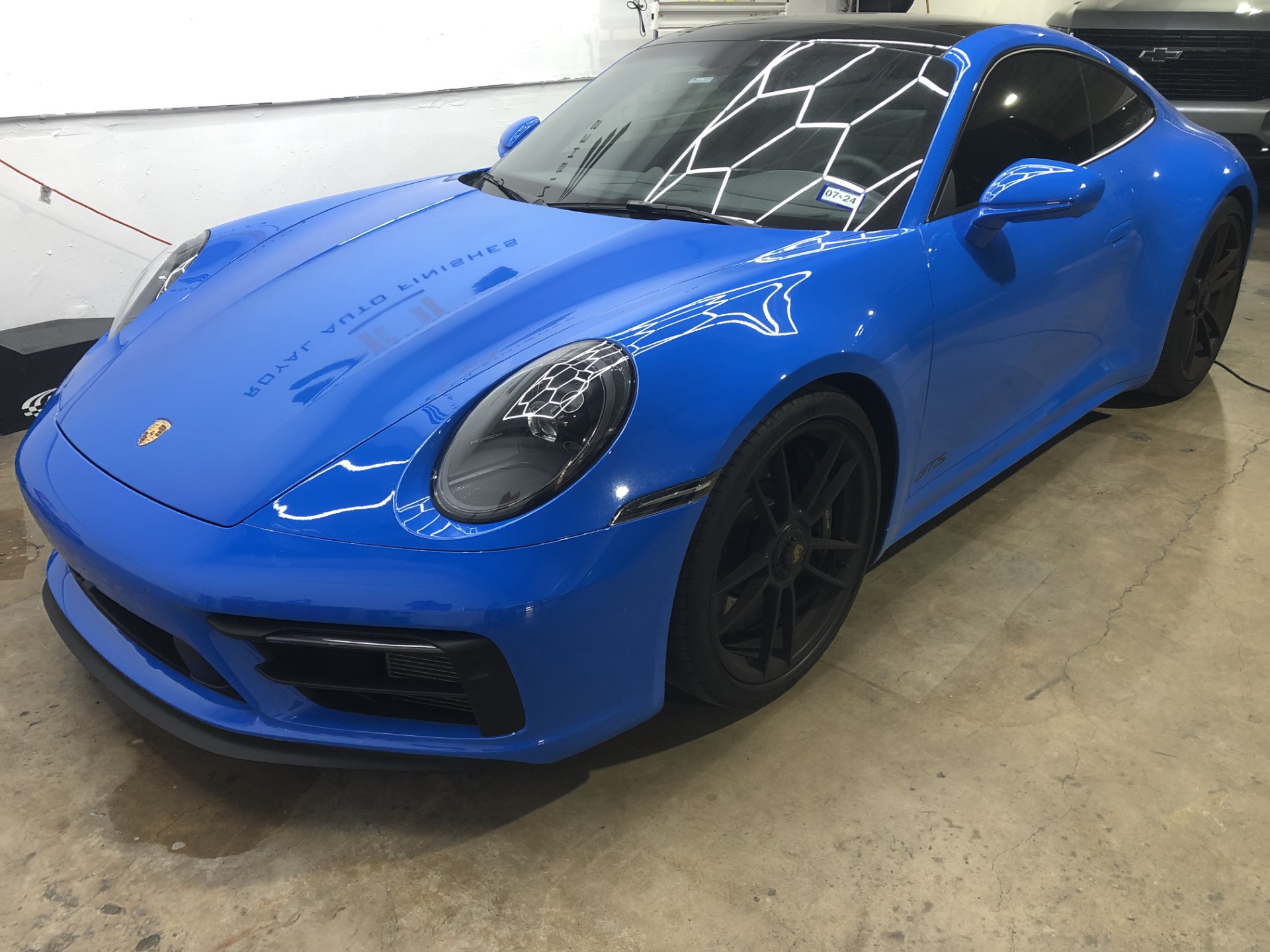 a blue sports car parked in a garage 