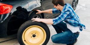 Man changing the car typre for repair services